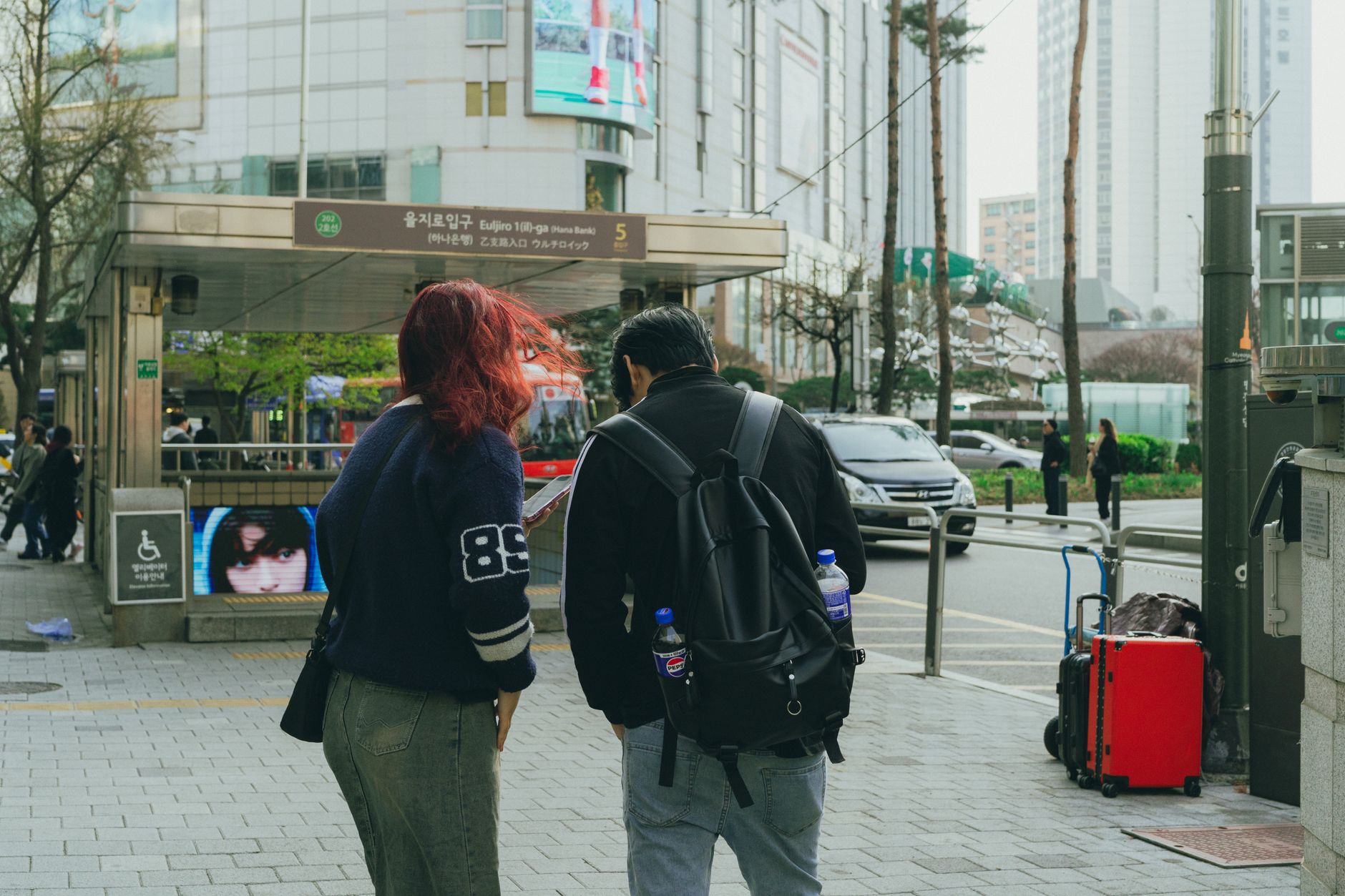 Street view capturing daily life in downtown Seoul, showcasing local architecture and vibrant atmosphere.