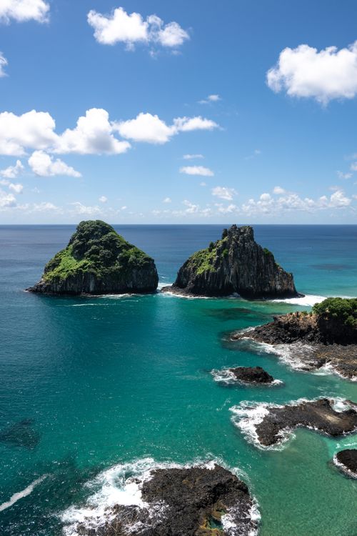 Free Explore the breathtaking seascape of Fernando de Noronha with its clear blue waters and iconic rock formations. Stock Photo
