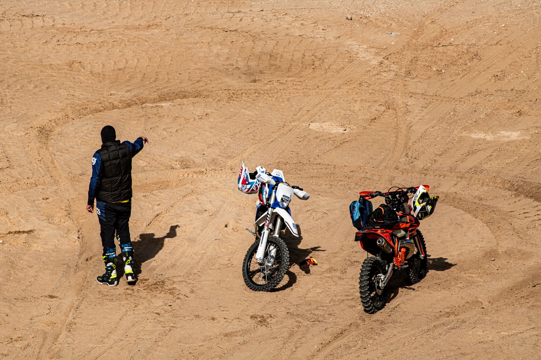 A rider prepares for an off-road motorcycle adventure in Lithuanian desert terrain.