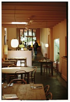 Inviting cafe interior with wooden tables, warm lighting, and a relaxed atmosphere.