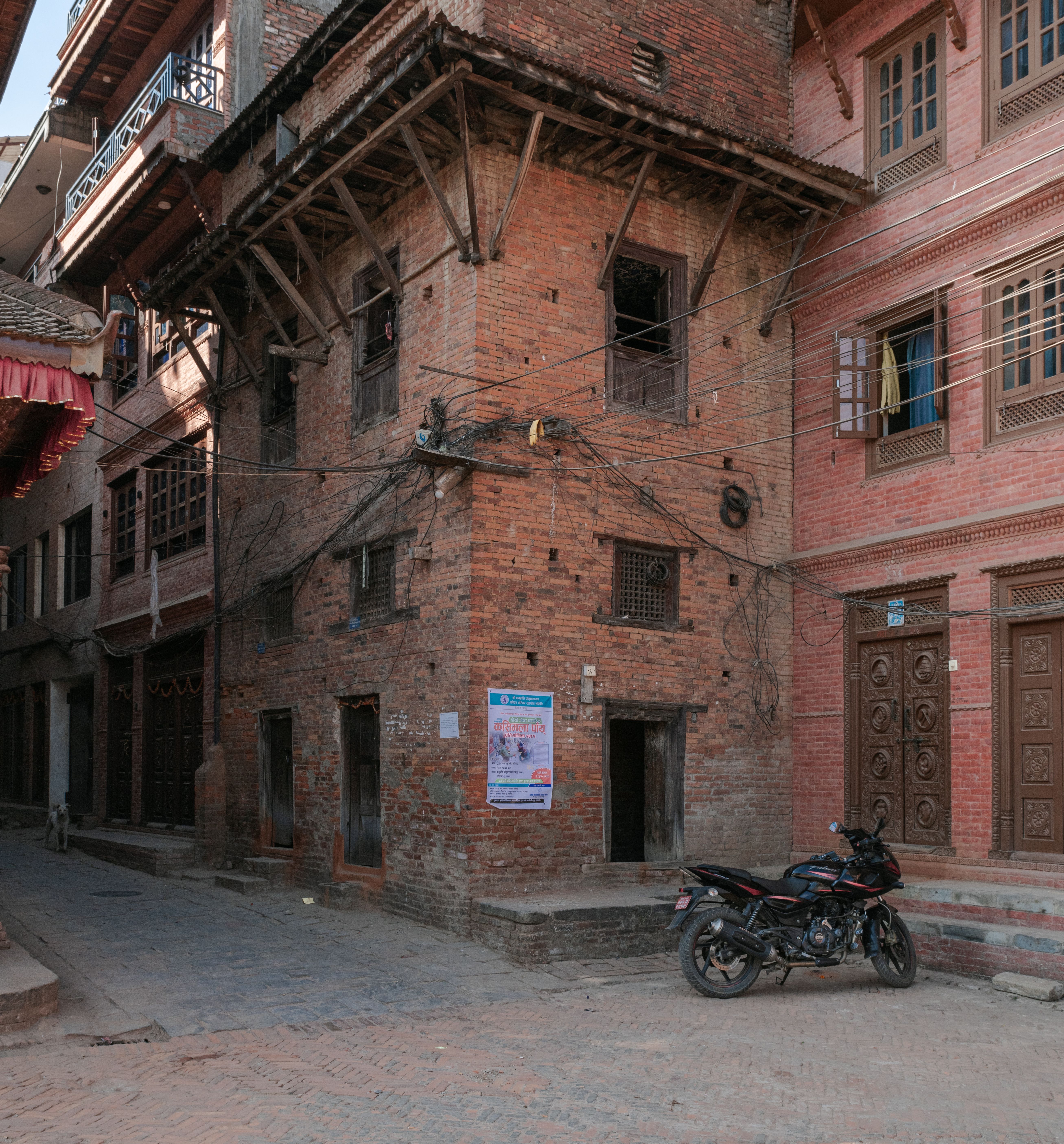 Authentic traditional brick architecture in a quiet street of Bhaktapur, highlighting local urban design in Nepal.
