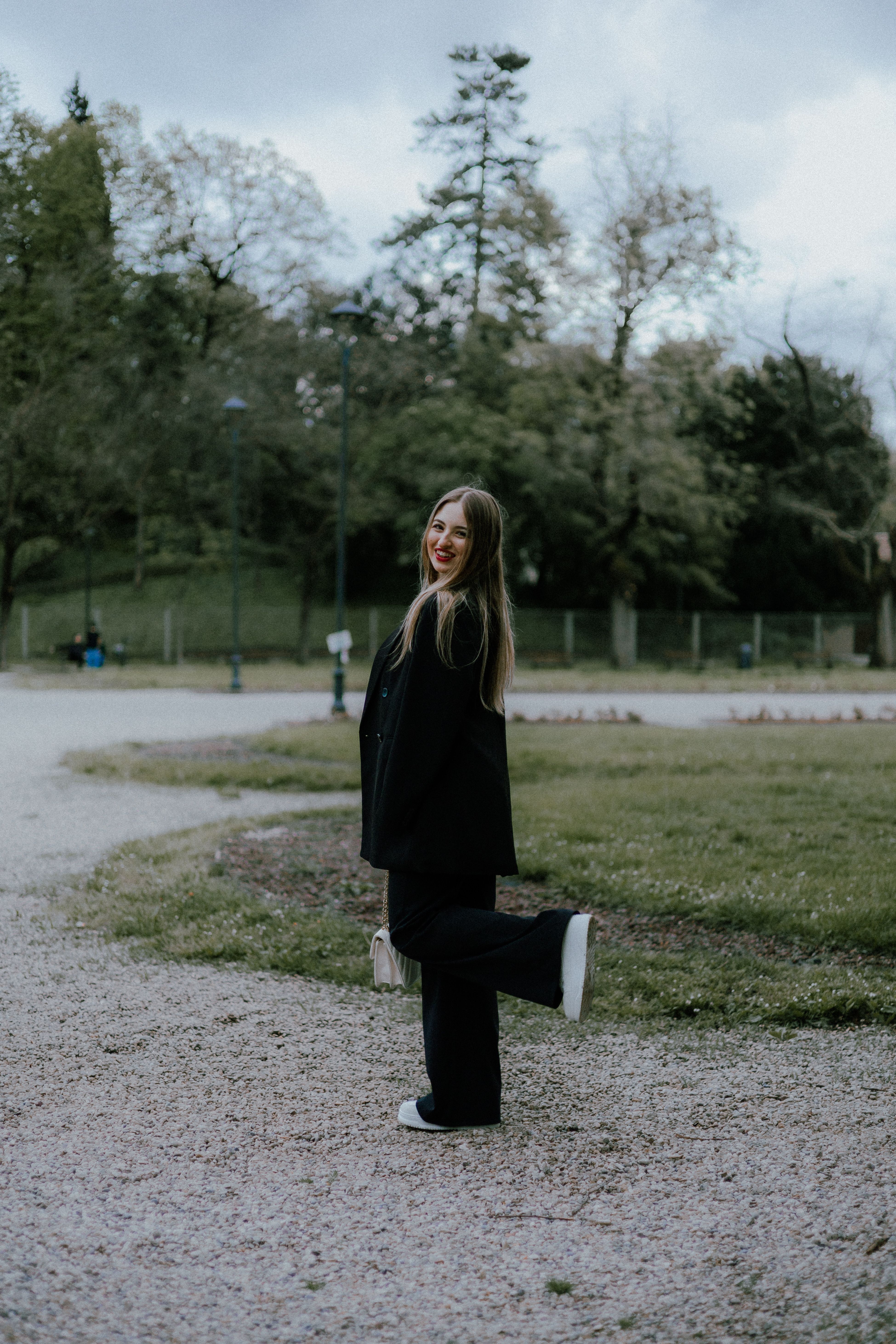 Happy Woman Posing Outdoors in Casual Outfit · Free Stock Photo