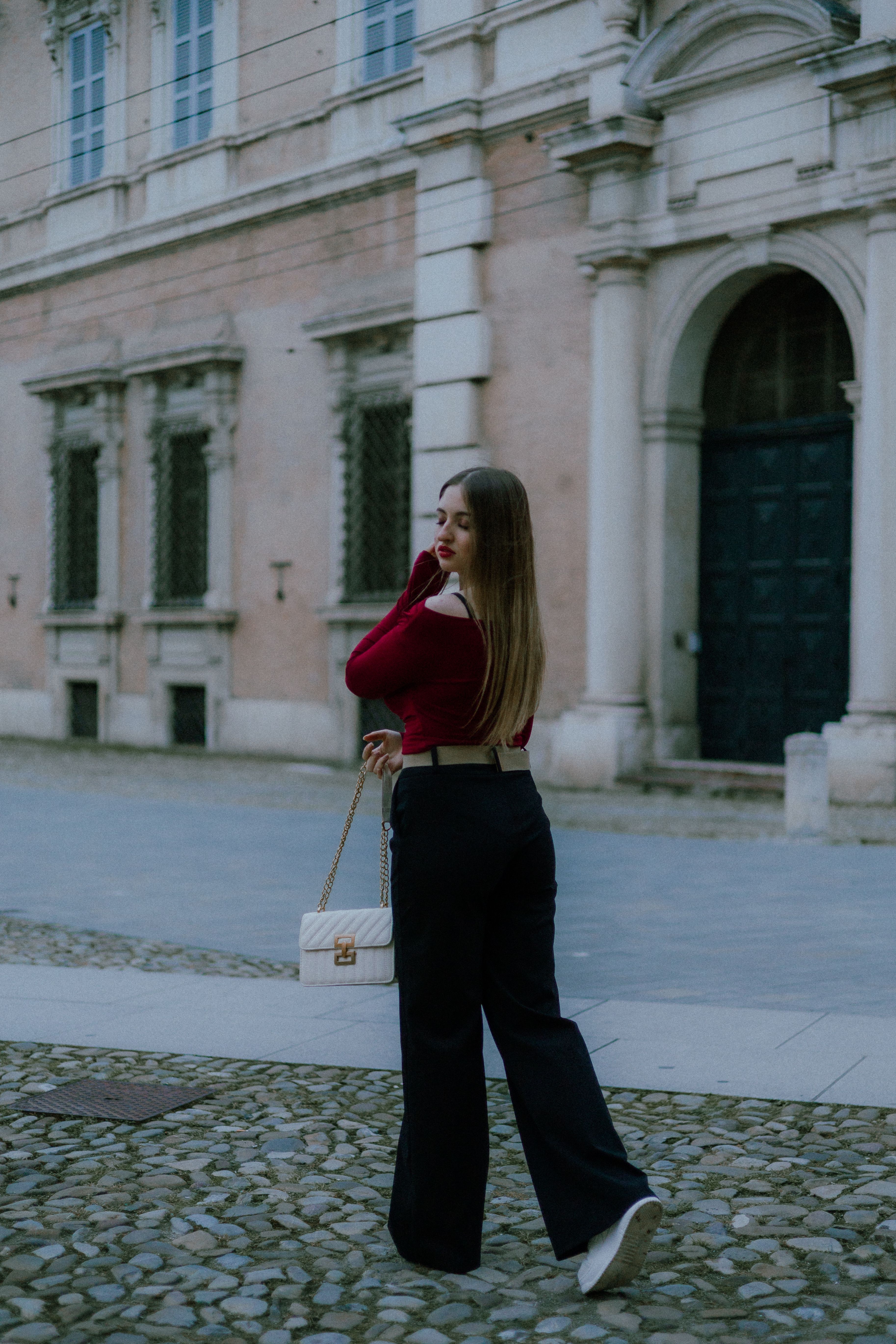 Stylish Woman Walking Near Historic Building · Free Stock Photo