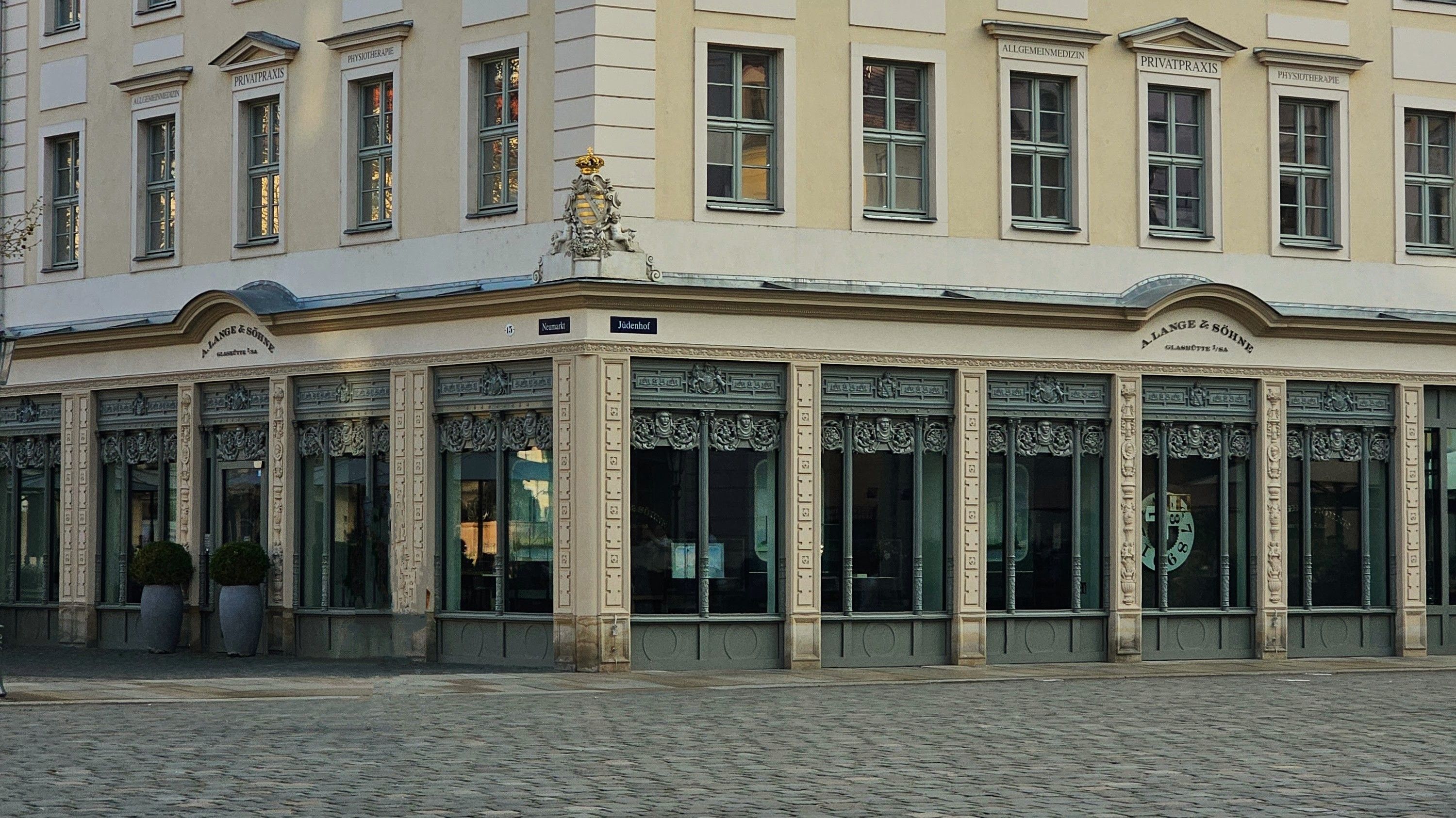Charming European corner building with intricate design elements and historical windows.