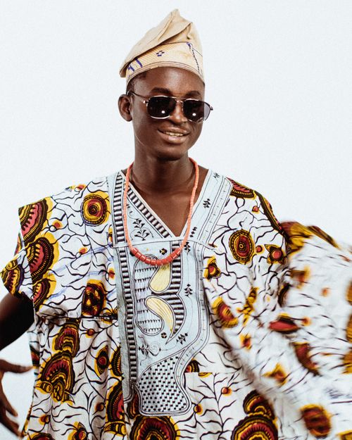 Free A person wearing traditional Yoruba attire with sunglasses, embodying style and culture. Stock Photo