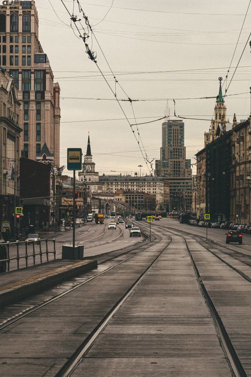 Free City street in Moscow featuring trams and historic architecture with cloudy sky. Stock Photo