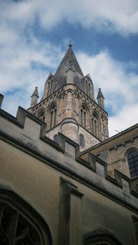 Gothic cathedral tower set against a blue sky in Oxford, England.