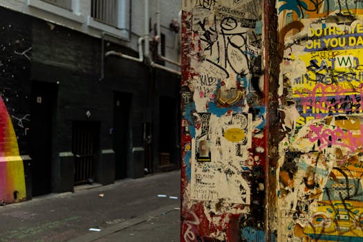 Colorful graffiti and street art line a laneway in Melbourne, showcasing urban life and creativity.