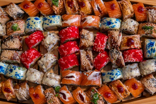 An overhead view of a colorful assortment of sushi rolls, showcasing vibrant and varied ingredients.