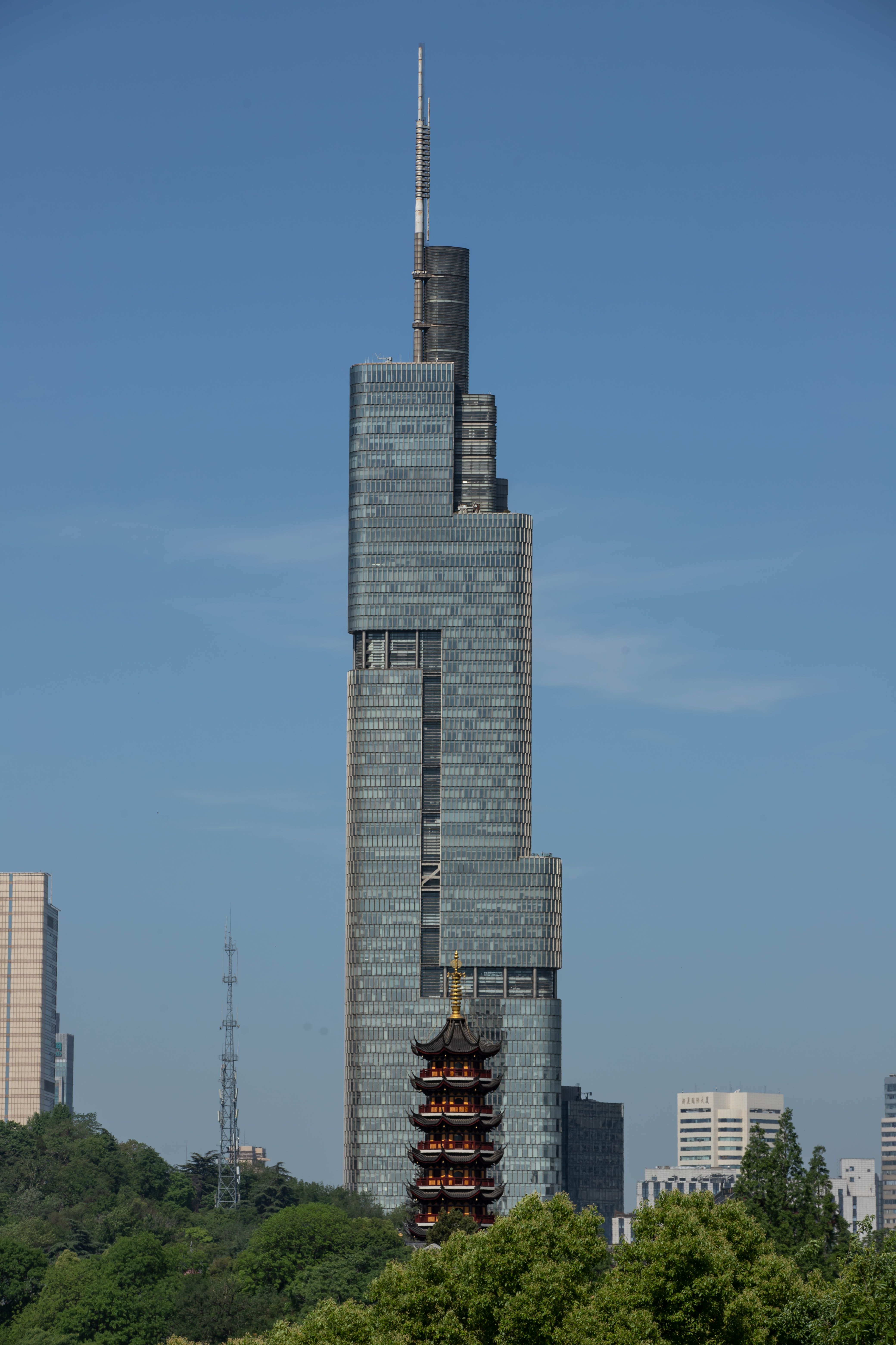 Zifeng Tower towering above the cityscape with a traditional pagoda in the foreground.