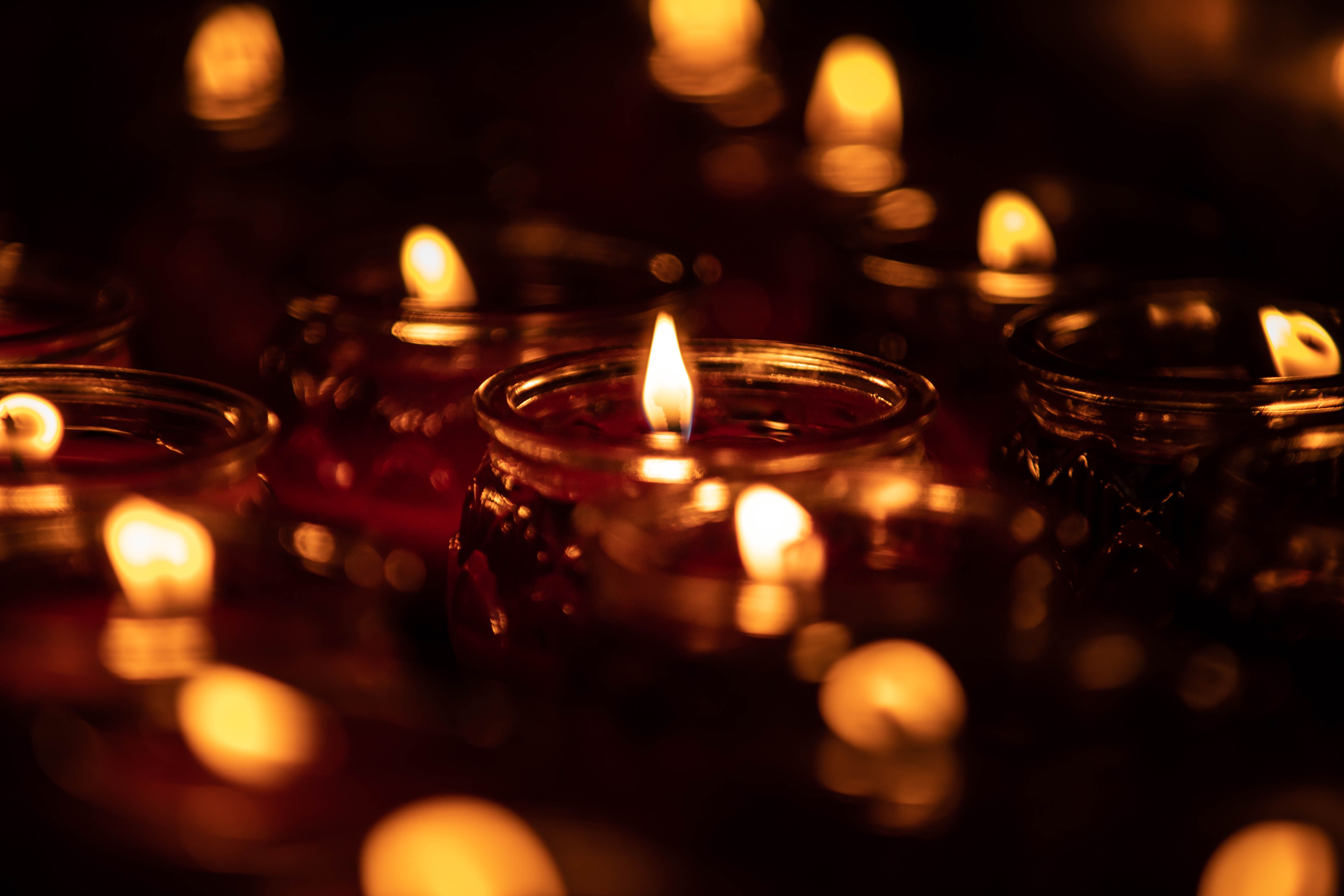 Romantic soft-focus candlelight creating a warm, cozy ambiance in the dark.
