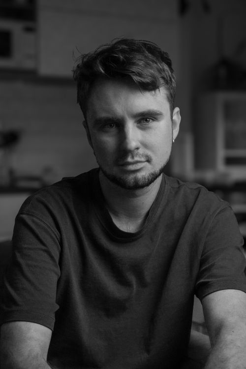 Free Black and white close-up portrait of a young man with a contemplative expression. Stock Photo