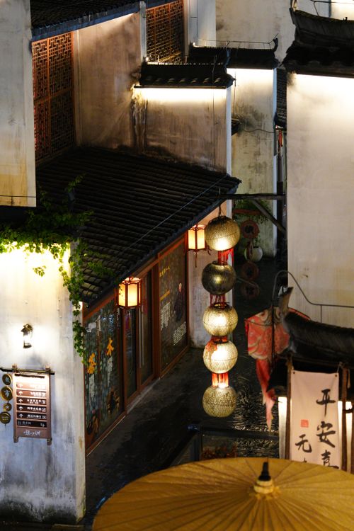 Free Illuminated street with traditional Asian architecture and lanterns at night. Stock Photo