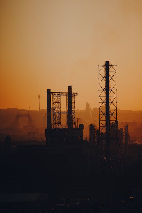 Безкоштовне стокове фото на тему «будівлі, забруднення повітря, Захід сонця»