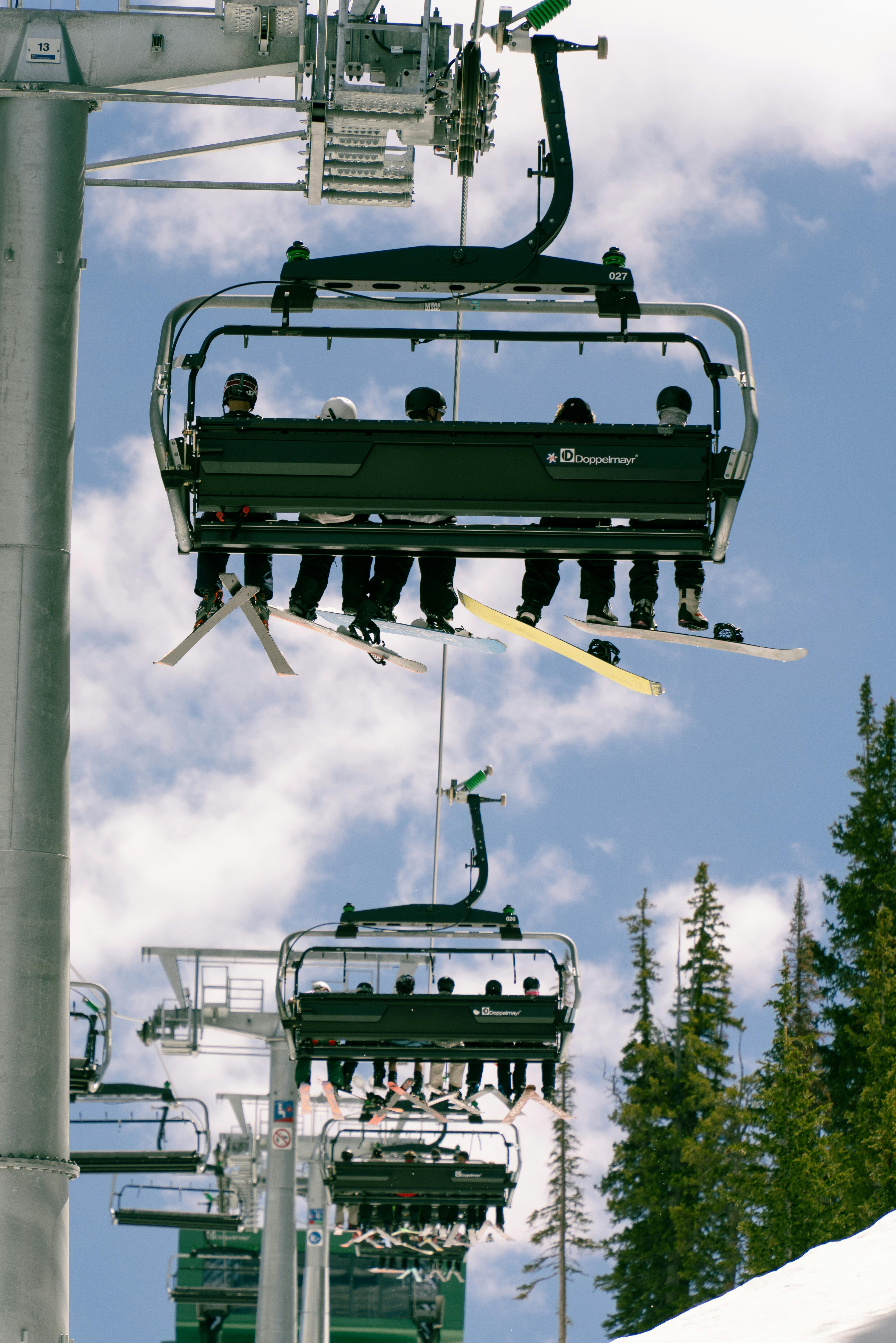 Skiers enjoy a sunny day on the chairlift at Brighton Ski Resort, Utah.