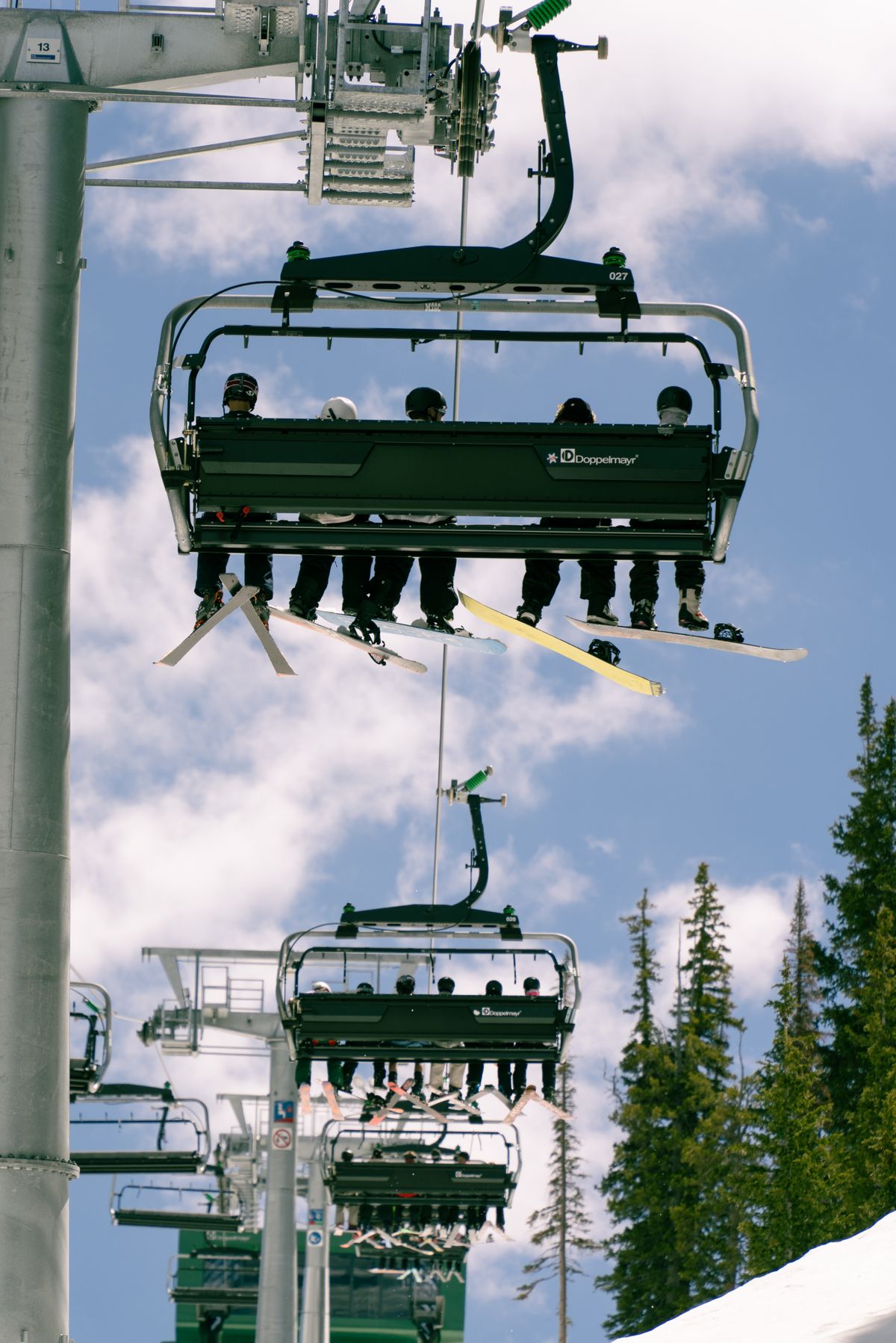 Skiers on chairlift at Brighton Utah on a bluebird day