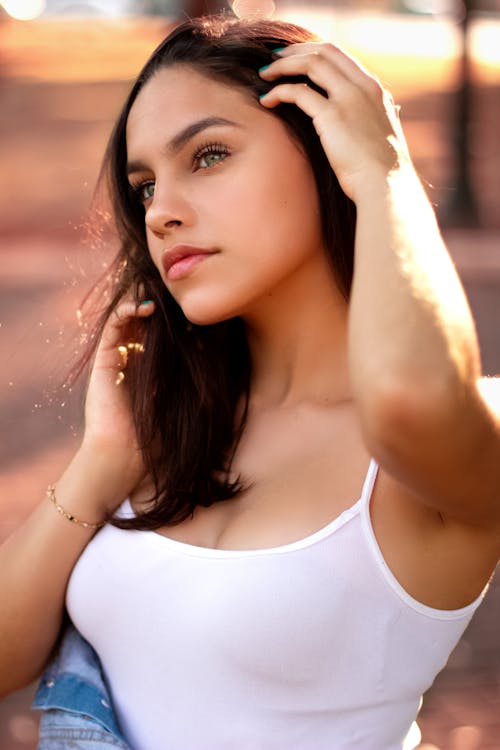 Close-up Of A Young Woman Wearing A White Tank Top