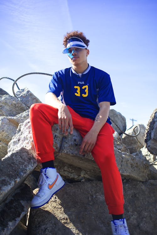 Photo Of Man Sitting On Rock