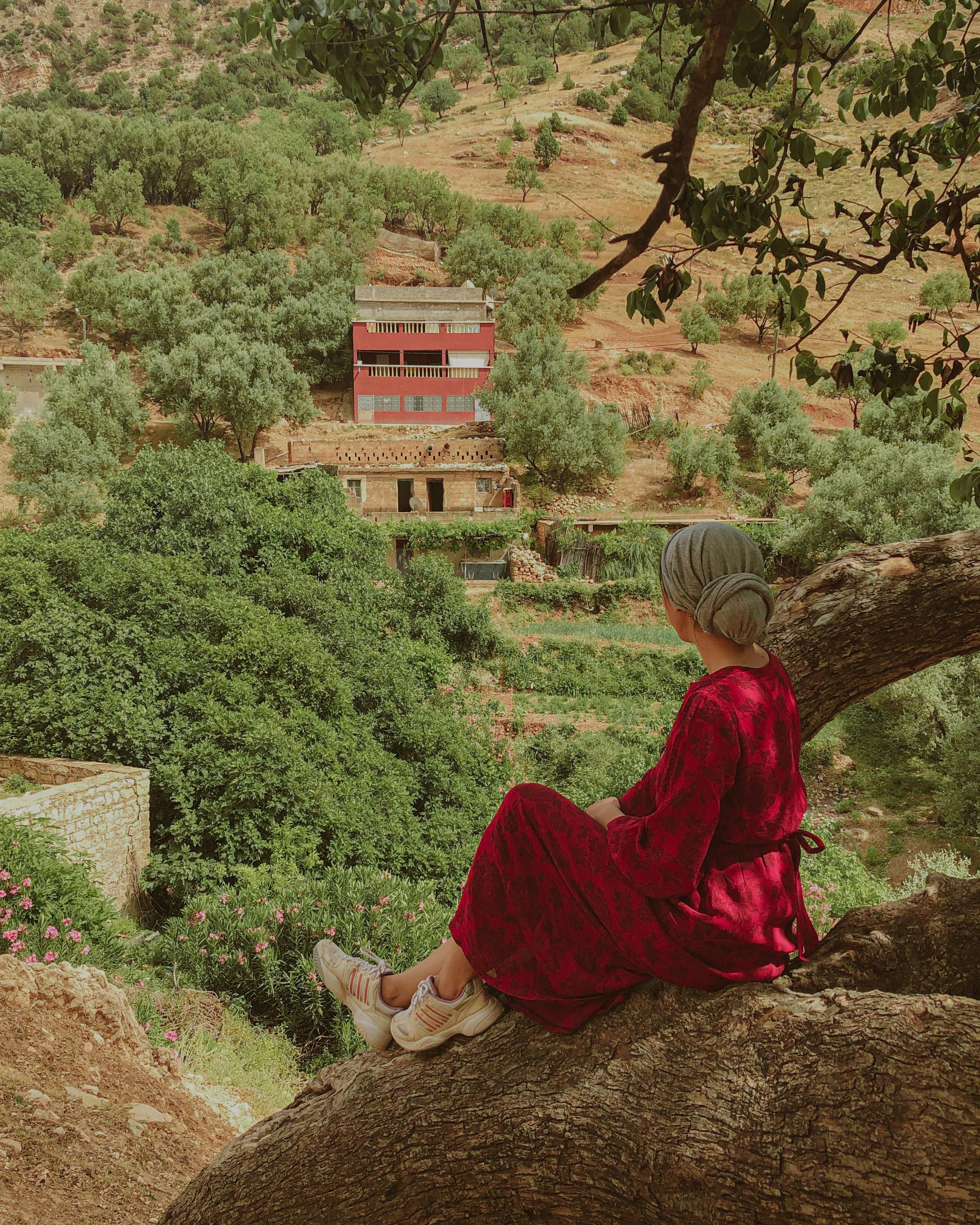 Woman in red dress enjoying scenic views in Béni Mellal-Khenifra, Morocco.