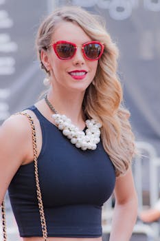 Elegantly dressed woman in New York City, showcasing stylish street fashion with red sunglasses.