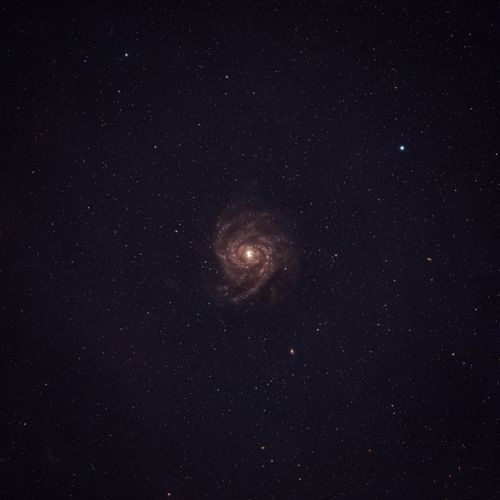 Free A mesmerizing view of a spiral galaxy surrounded by a myriad of stars in the dark night sky. Stock Photo