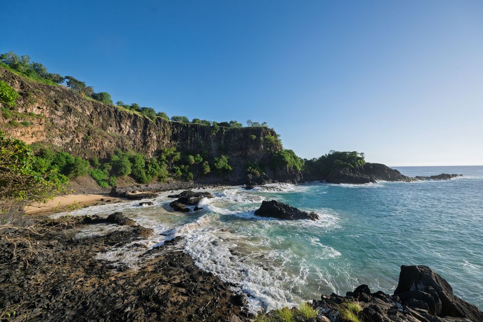 Dramatic cliffs and pristine waters on a sunny day in Pernambuco, Brazil.