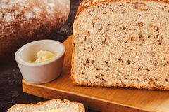 Delicious freshly baked artisan bread with butter spread, perfect for a healthy breakfast.