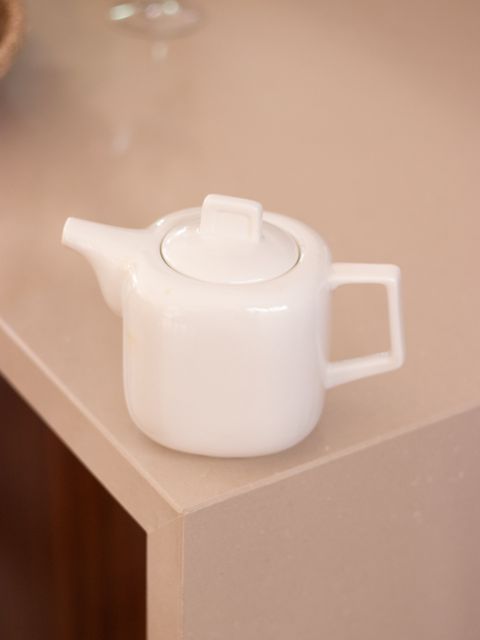White ceramic teapot on a counter