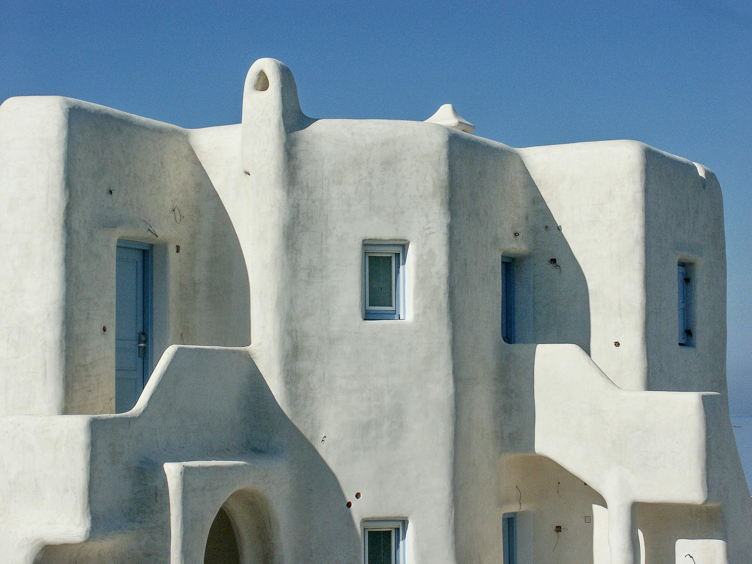 Beautiful whitewashed Cycladic building in Mykonos, Greece, under a clear blue sky.