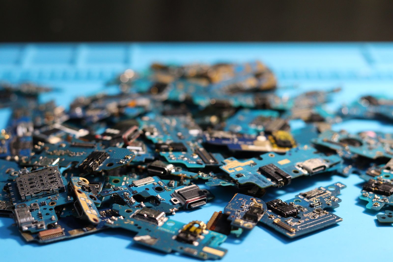 enterprise hardware decommissioning data sanitization compliance: disassembled electronic circuit boards after asset recovery.