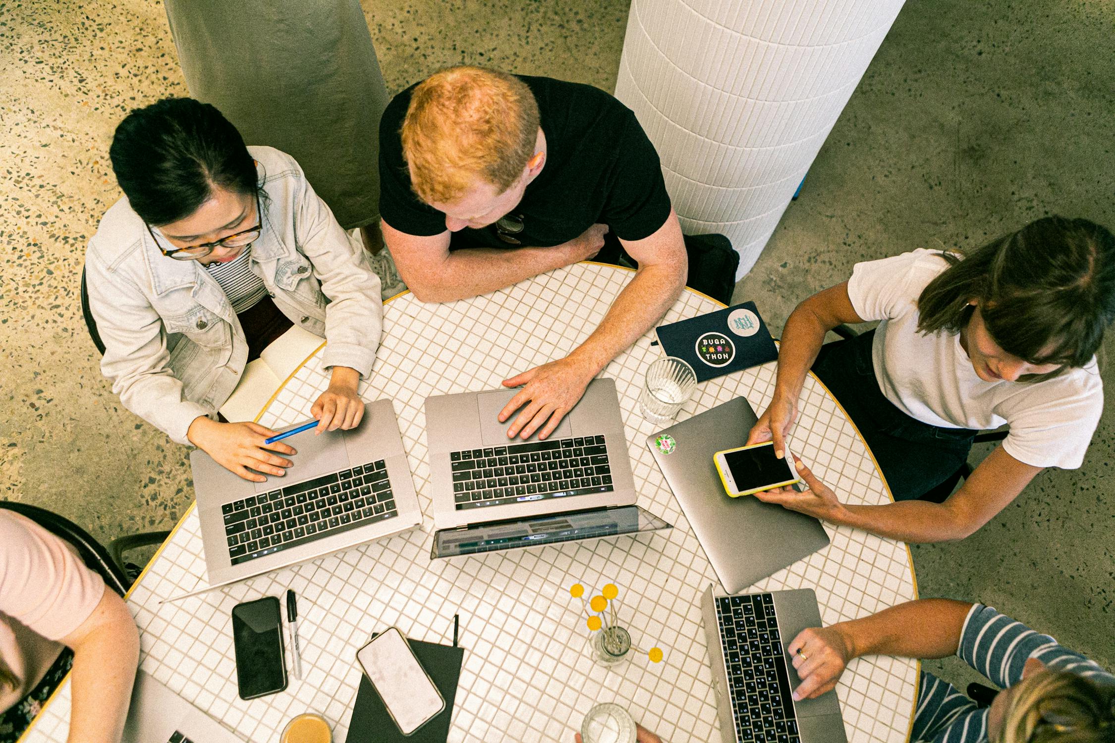 A group of people using smartphones and tablets