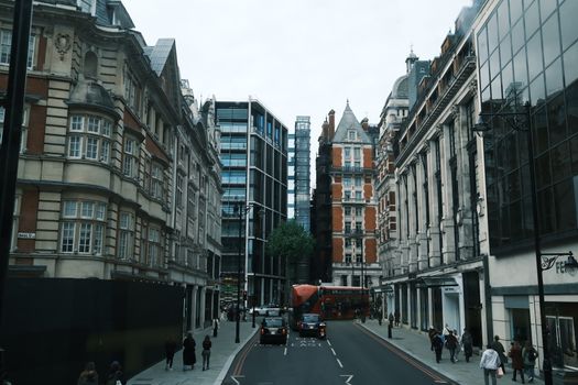 Dynamic cityscape of London featuring historic and modern buildings with a red double-decker bus.
