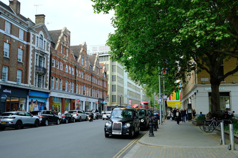 Lively London street with historic buildings showing classic flat-over-shop architecture relevant to ATED mixed-use apportionment