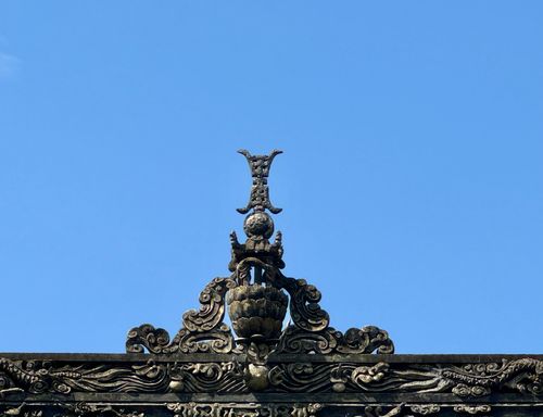 Free Intricate stone carving with decorative elements set against a clear blue sky. Stock Photo