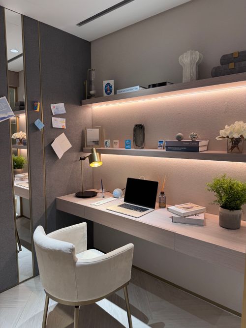 Free Cozy modern home office setup with laptop and decorative items on a sleek desk. Stock Photo