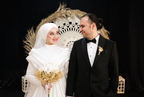 Free Beautiful couple smiling and looking at each other on their wedding day indoors. Stock Photo