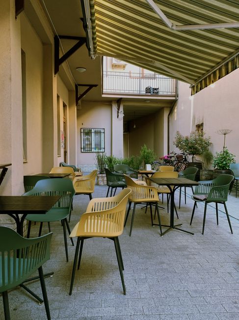 Inviting outdoor cafe terrace with stylish chairs and tables, perfect for a relaxed setting.