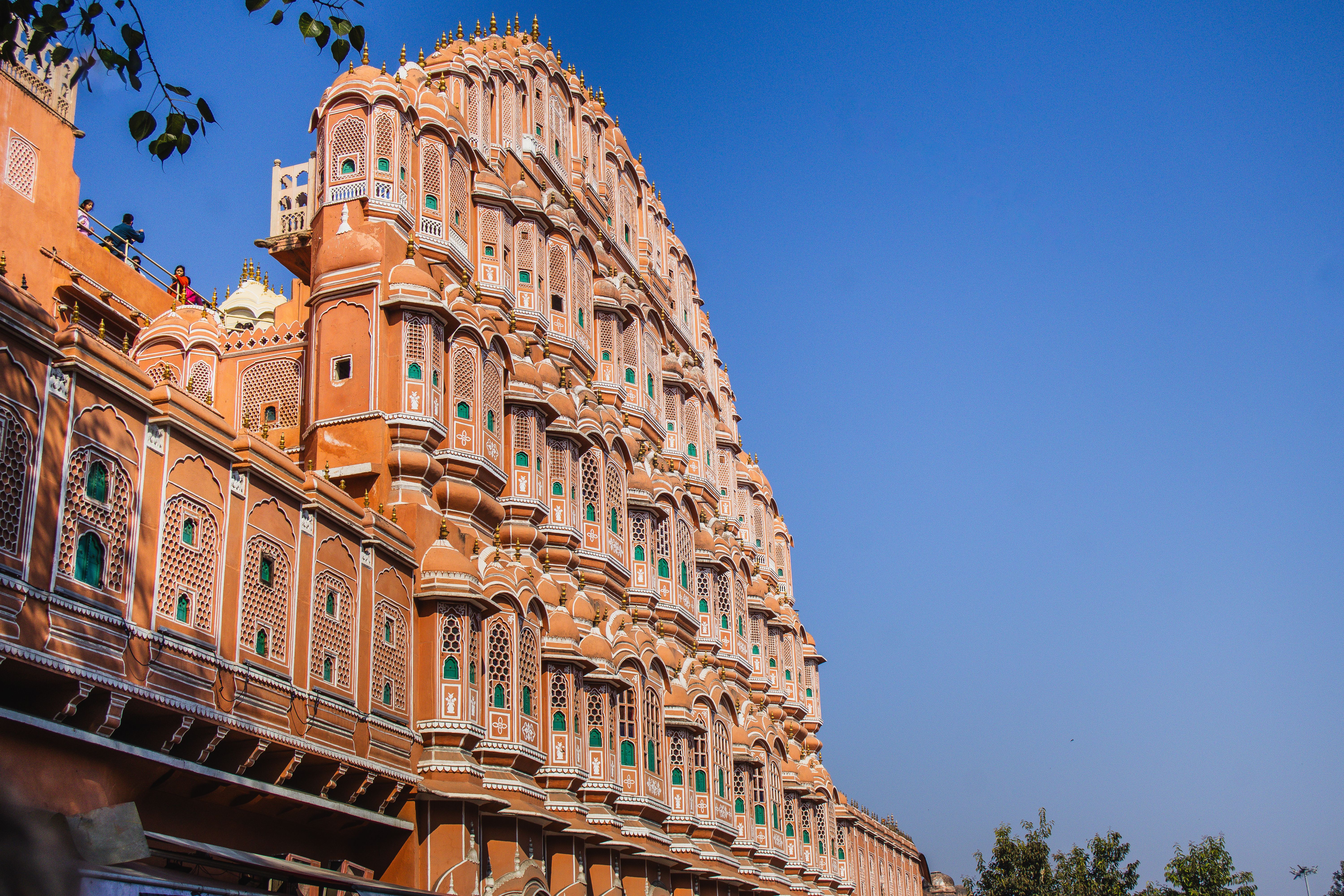 Stunning architectural view of Hawa Mahal under a clear blue sky in Jaipur, India.