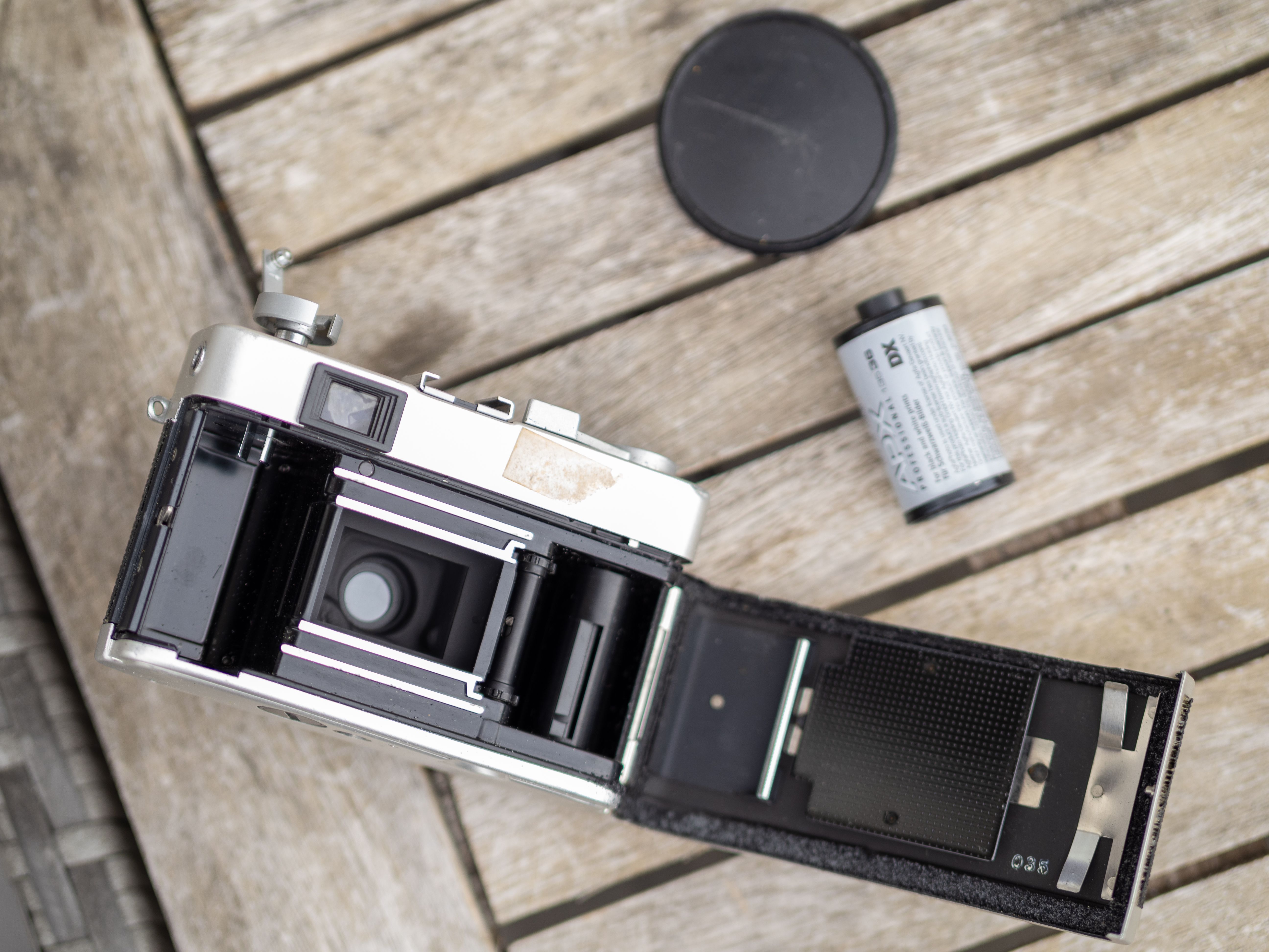 Open Analog Camera with Film on Wooden Table · Free Stock Photo