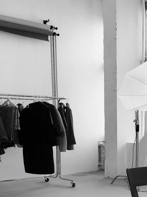 Grayscale Photography of Studio With Clothes