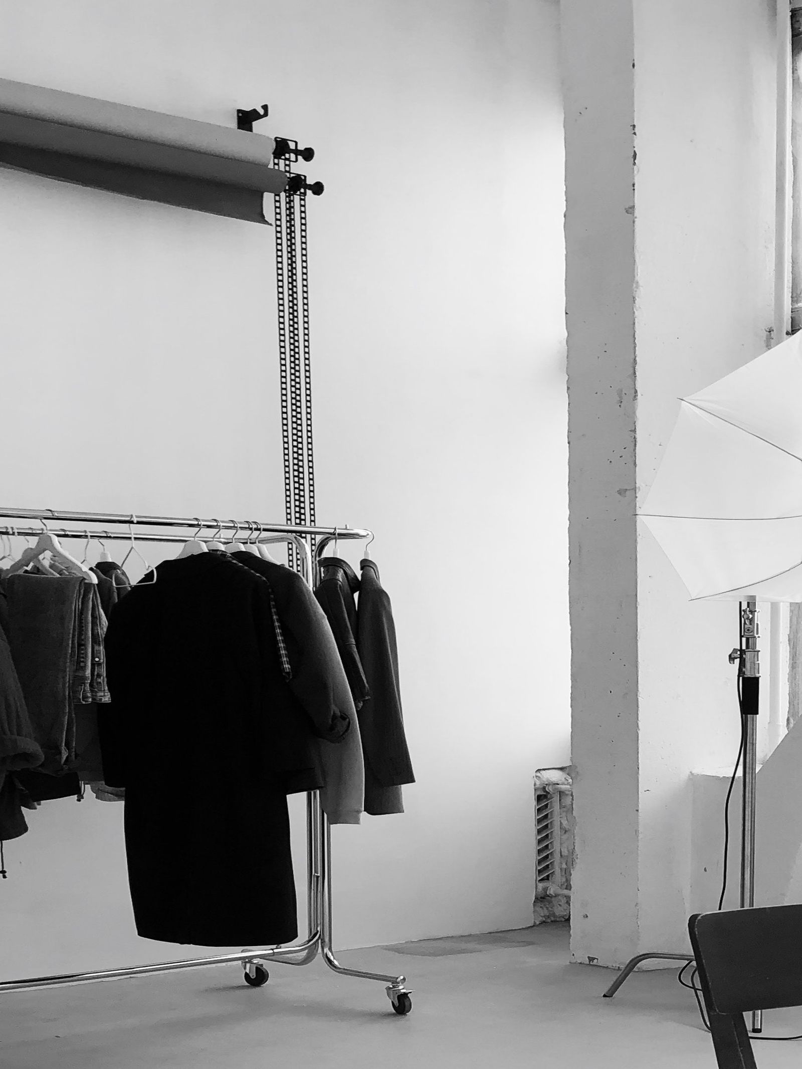 Apparel studio with clothing racks and professional lighting rig