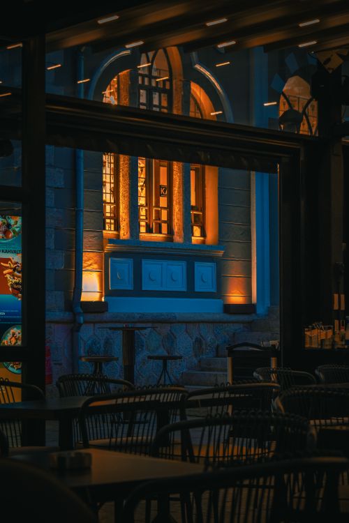 Free Ambient outdoor dining area with soft lighting and elegant architecture. Stock Photo