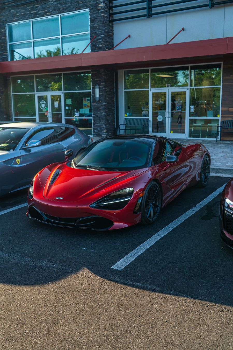 Tesla Model S Plaid, red sedan parked in an urban setting