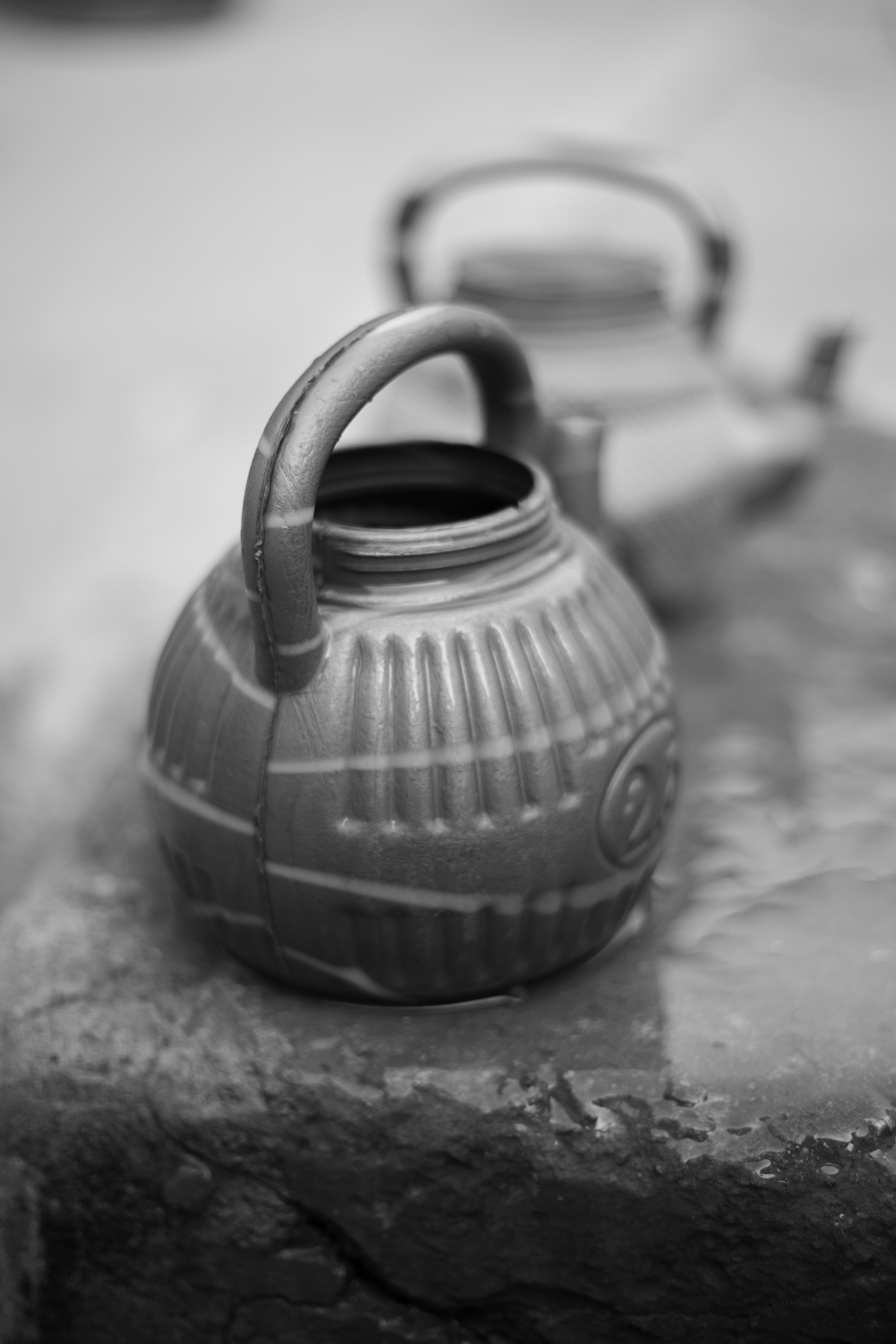 Close-up of vintage teapots in black and white creating a nostalgic and artistic feel.