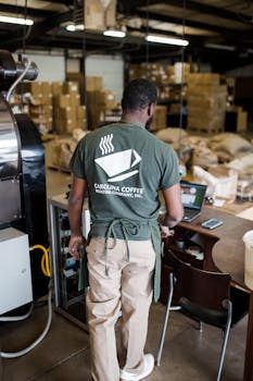 Worker managing coffee roasting at Carolina Coffee in Greensboro, NC