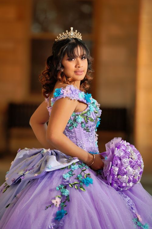 Free A young woman in a lavender quinceañera dress with a floral bouquet, indoors. Stock Photo