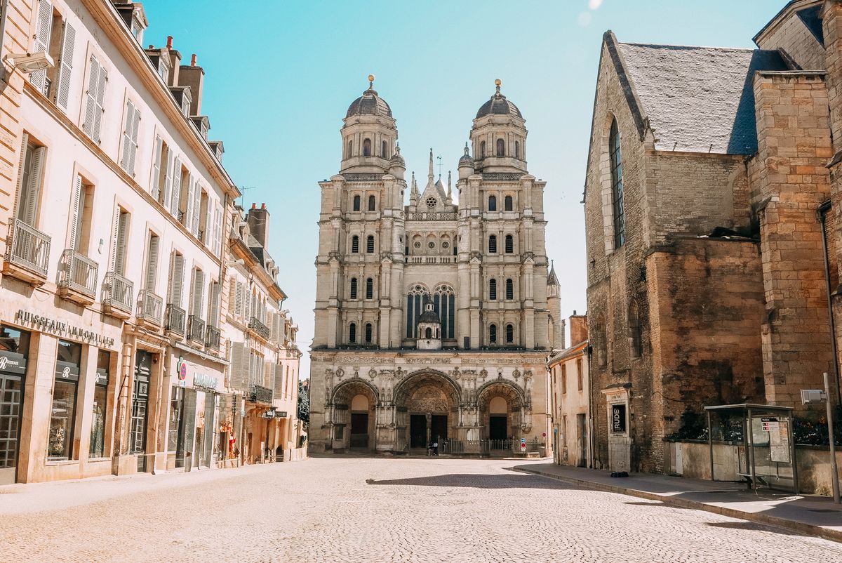 A Dijon church facade over a cobbled square