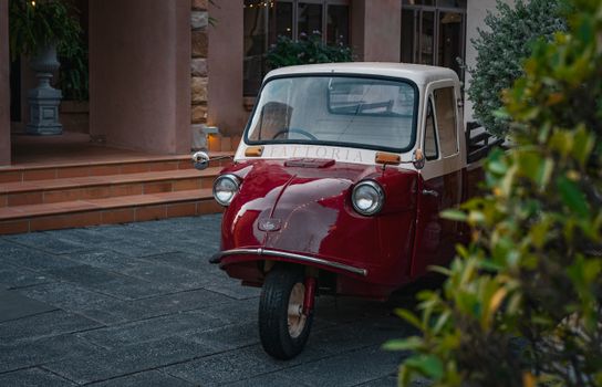 Charming retro three-wheeled vehicle in Thailand, captured outdoors in a serene setting.