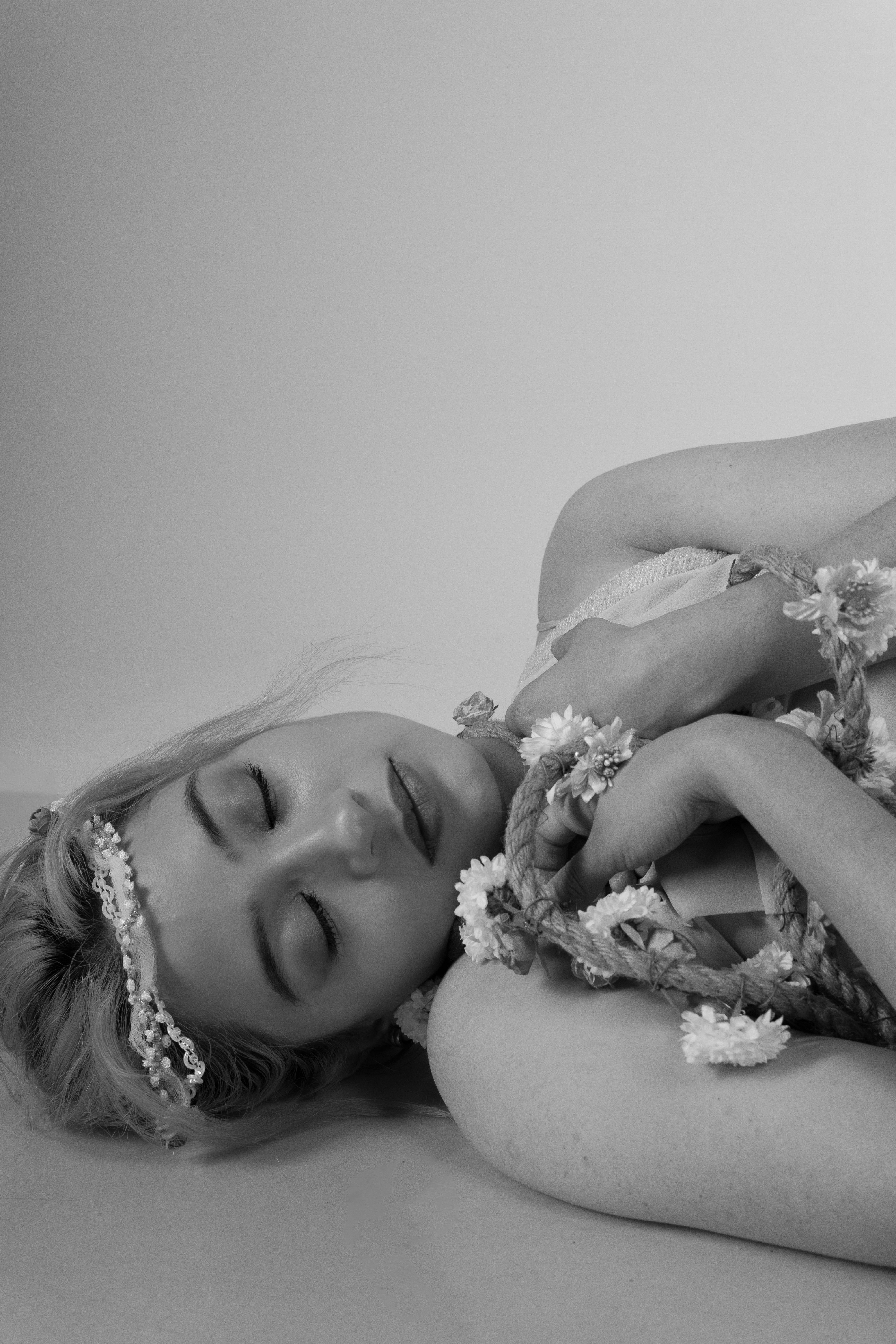 Elegant Ballet Dancer Resting with Floral Accents · Free Stock Photo
