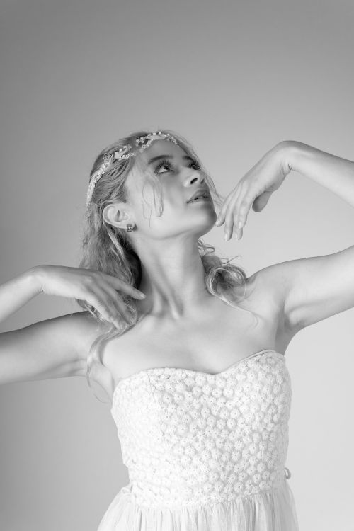 Free Black and white portrait of a ballet dancer in a graceful pose wearing a floral dress. Stock Photo